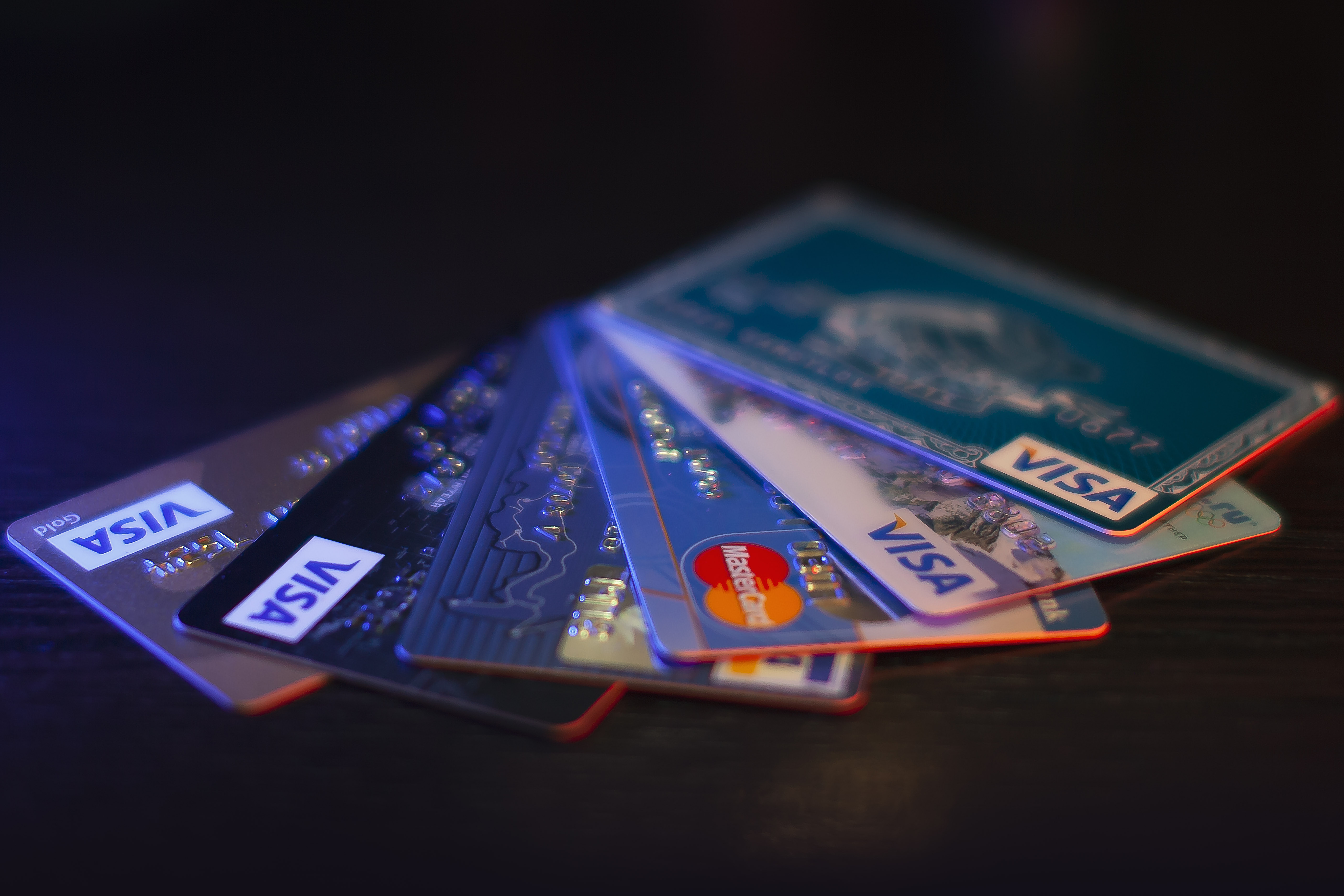 Bunch of credit cards on dark background with DOF. This image provided under the Creative Commons Attribution 3.0 license. You can copy, distribute, adopt and transmit the work for