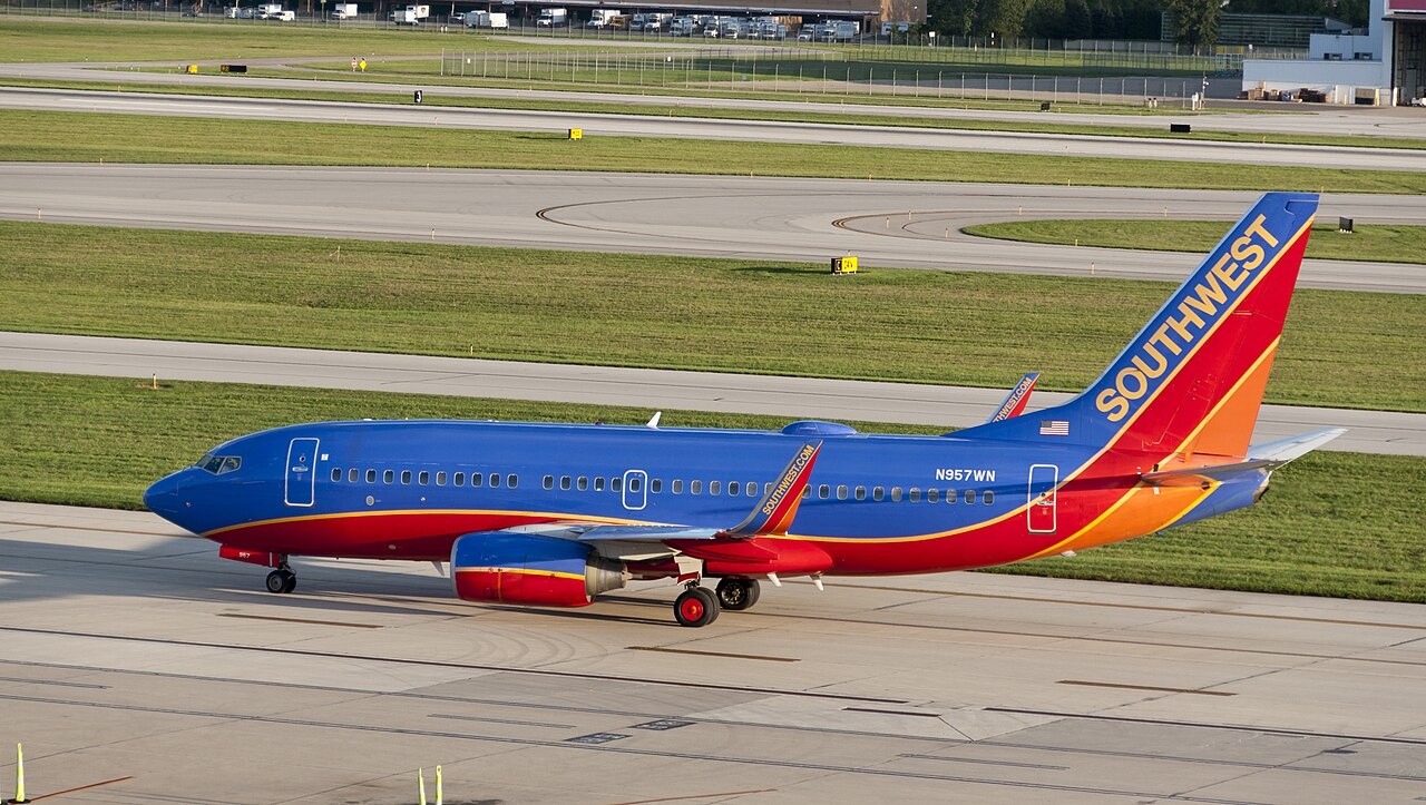 A Southwest Boeing 737-700 with the Tail number N957WN, preparing to take off on an August evening from KCMH .